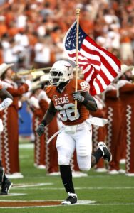texas player holding u s a flag on field