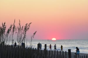 The 10 Hottest Up and Coming Cities in the United States 5 people at the beach during sunset