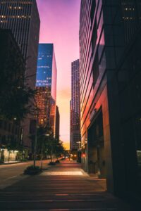 empty street between high rise buildings during nighttime of Austin which is one of the coolest cities in America