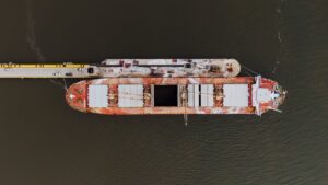 barge moored on sea near pier in port