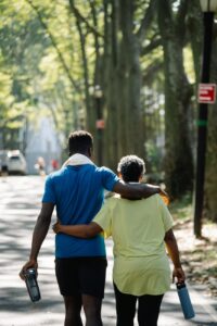 back view of people walking on the street together while holding their tumblers